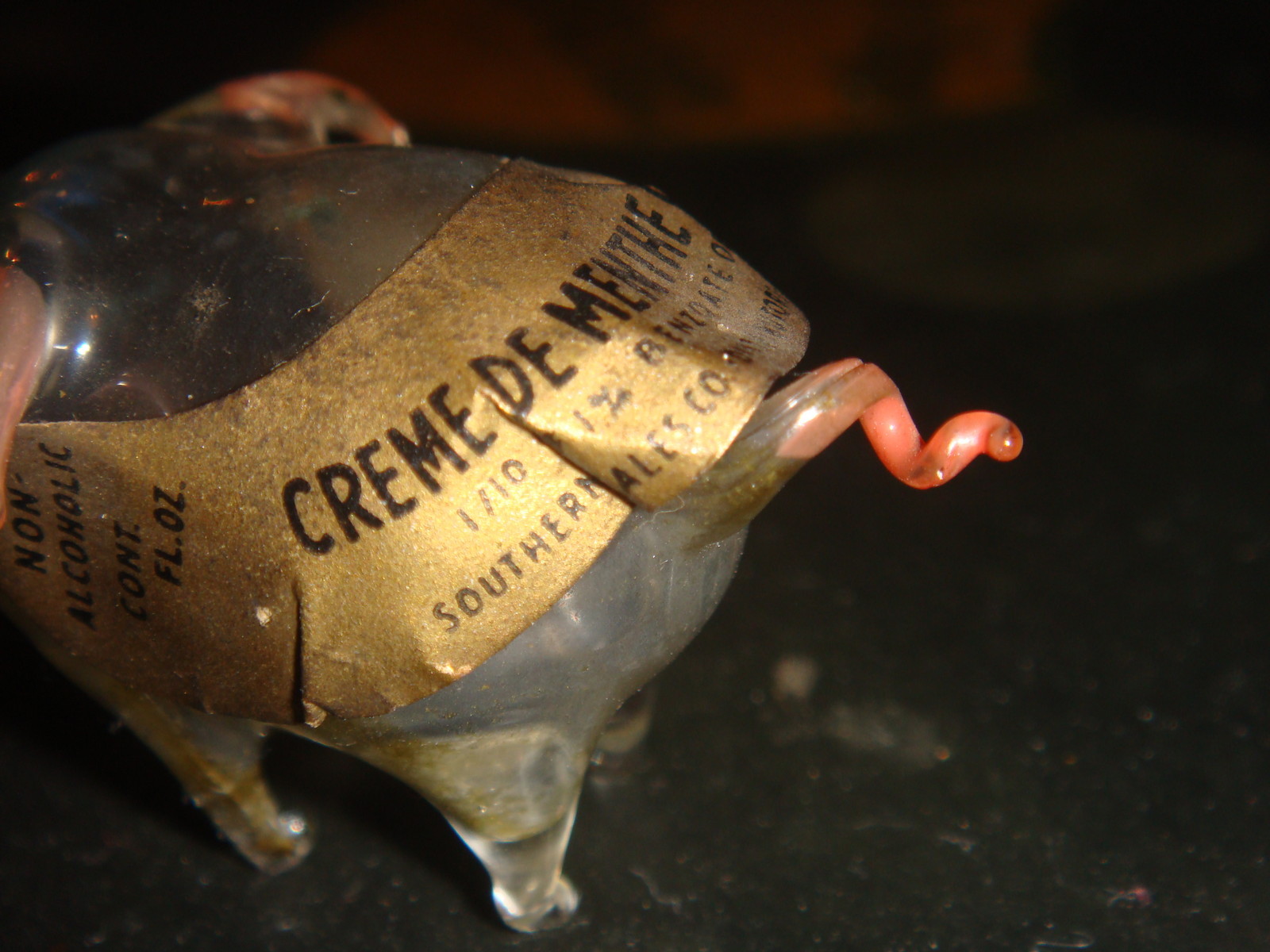 Creme de Menthe Cordial. Its ears and curly pig tail is pink