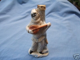 Miniature Boccaccio figural hooded man instrument