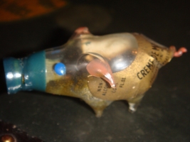 Creme de Menthe Cordial. Its ears and curly pig tail is pink